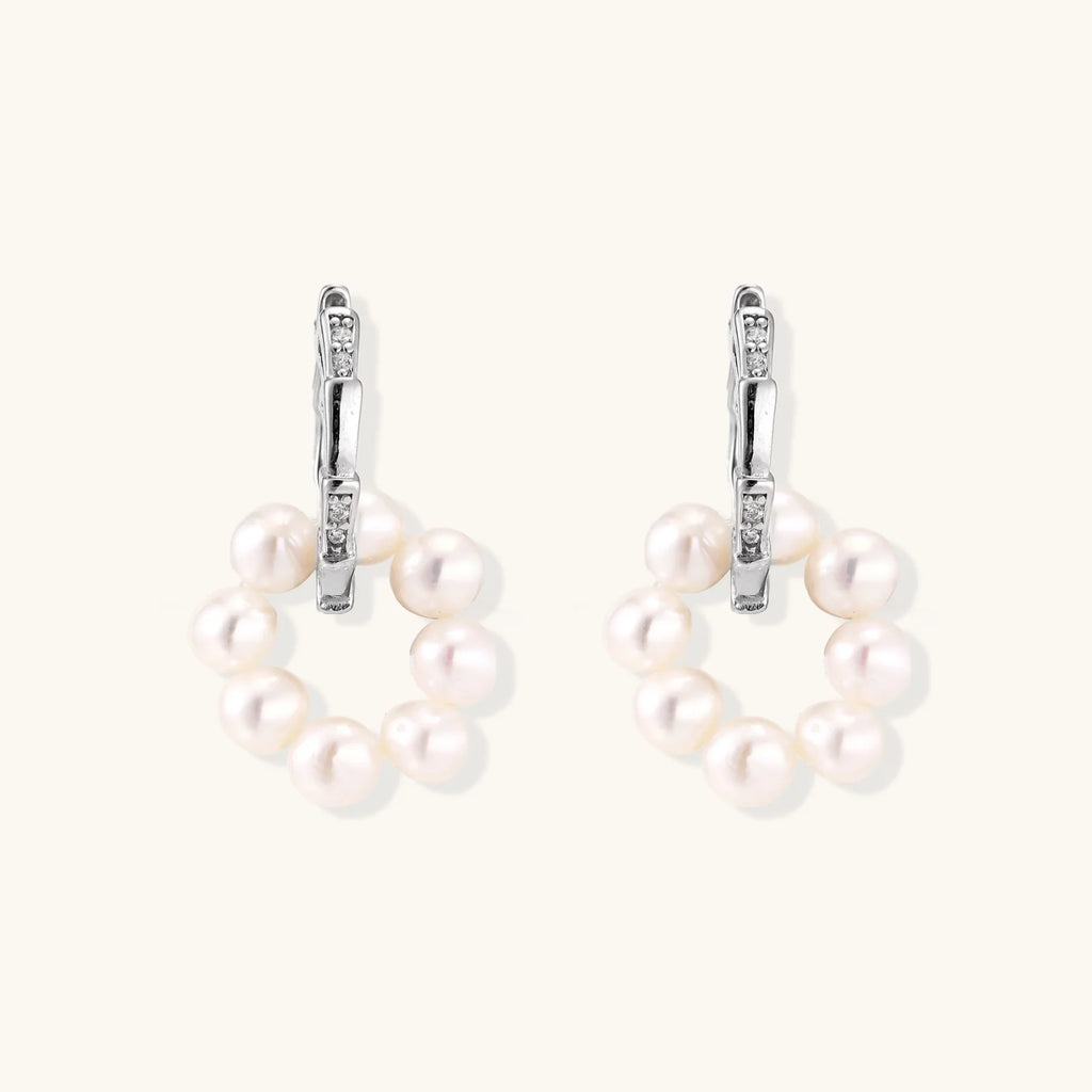 Rhodium-plated silver hoop earrings with freshwater pearls arranged in crescent formation and diamond accents
