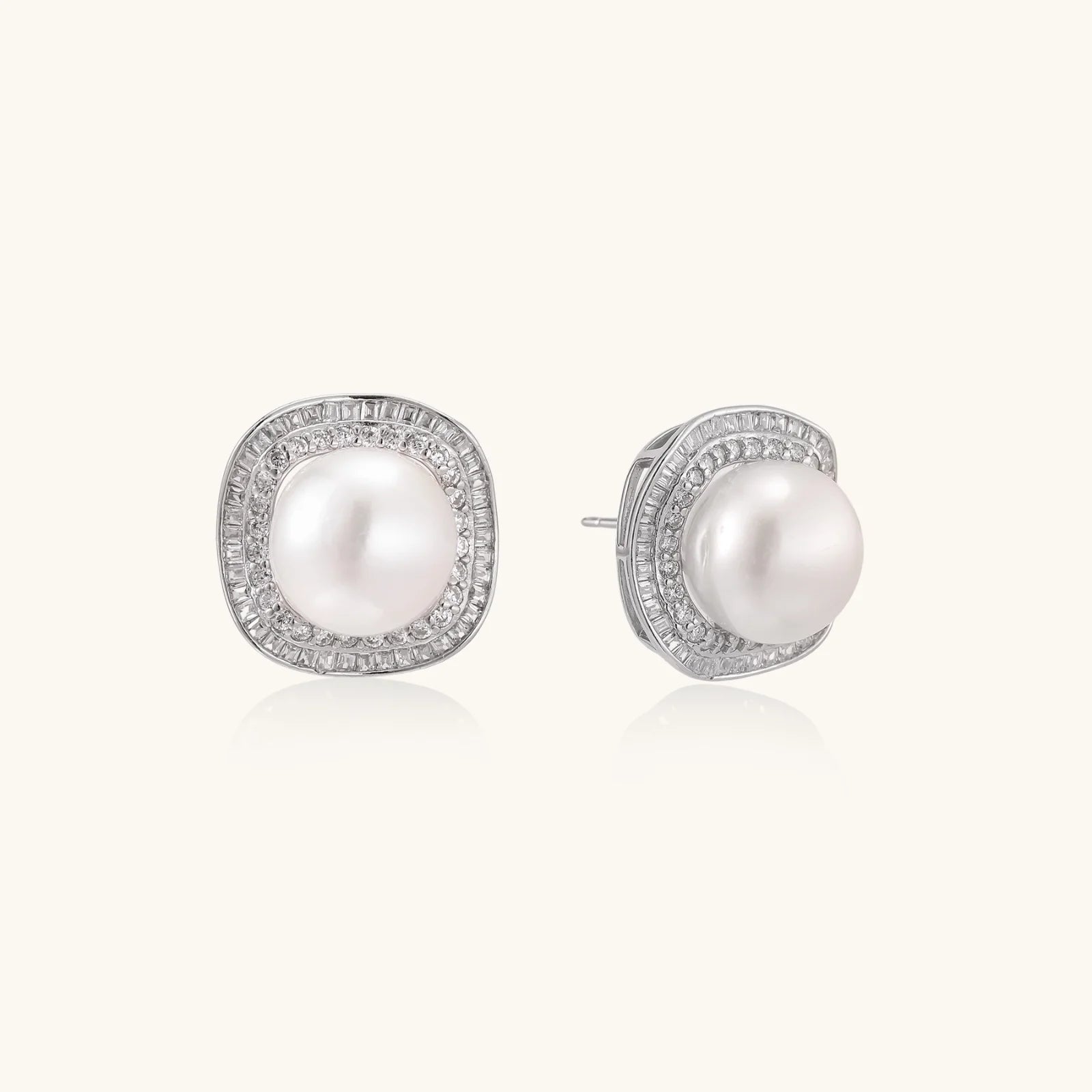 Cushion-shaped sterling silver stud earrings with freshwater pearls surrounded by geometric diamond halos