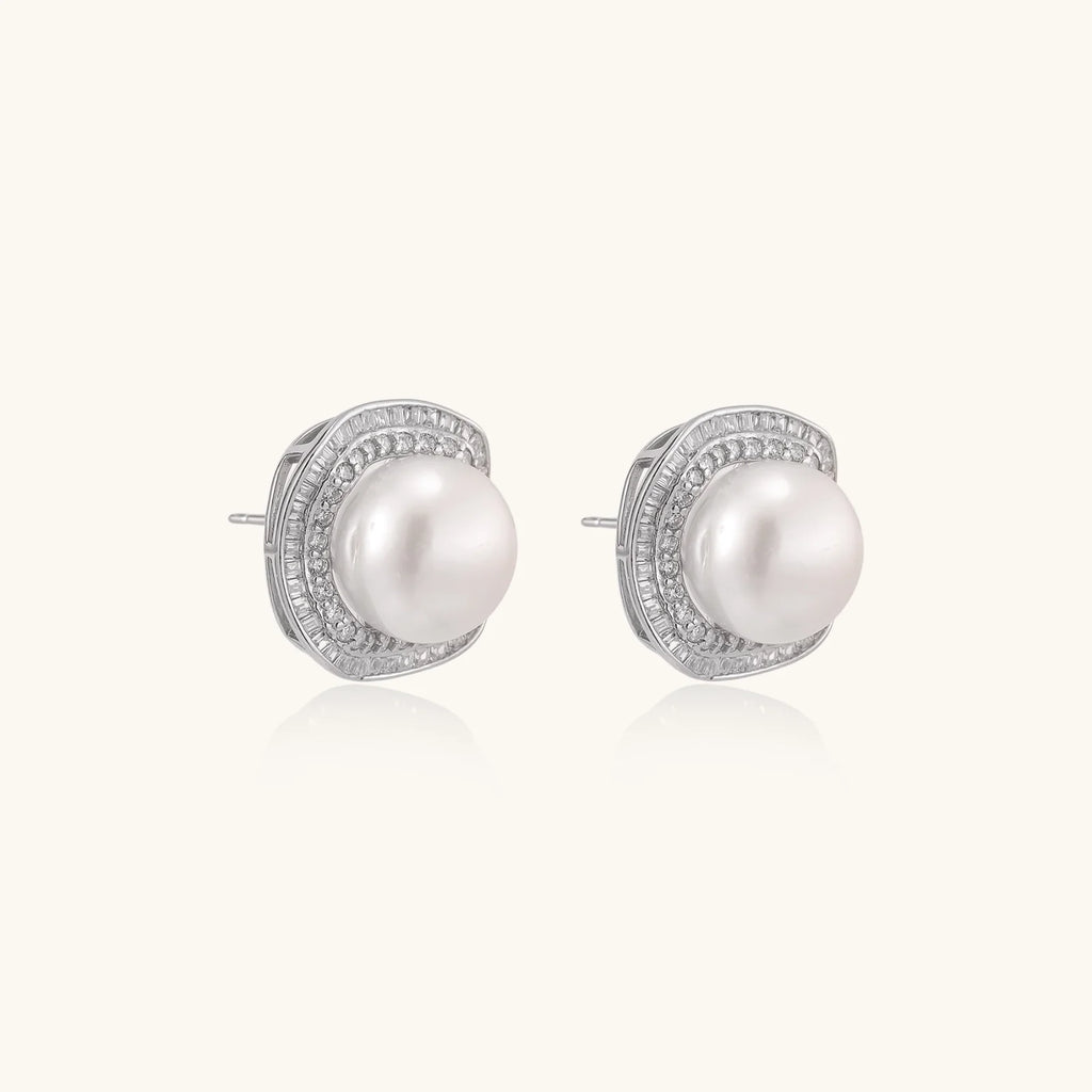 Cushion-shaped sterling silver stud earrings with freshwater pearls surrounded by geometric diamond halos
