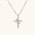 White gold-plated cross pendant adorned with sparkling zirconia stones and crescent moon accent on ball chain