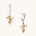 Two-tone cross earrings with gold roses and crystal stars on silver hoops, dangle drop style on white background.