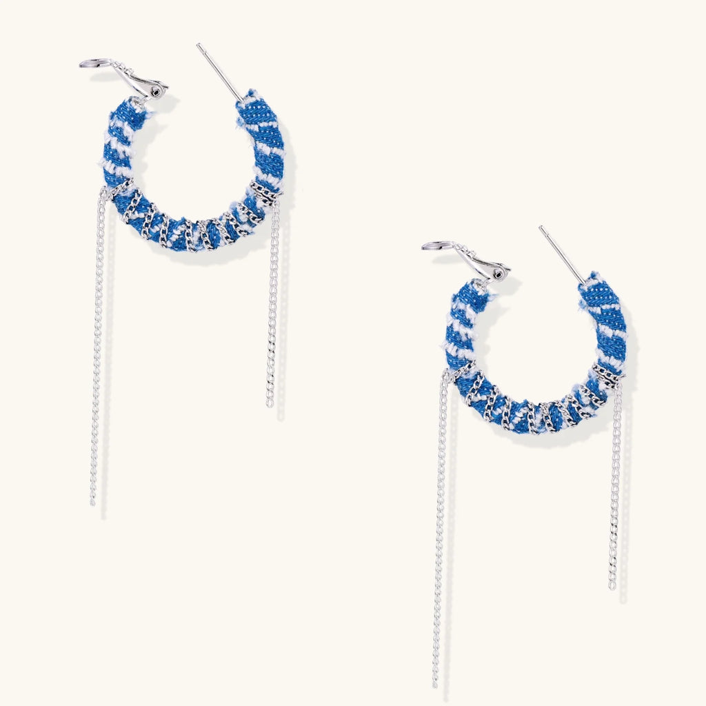 Medium hoop earrings wrapped in blue striped denim fabric with dangling silver chains on white background.