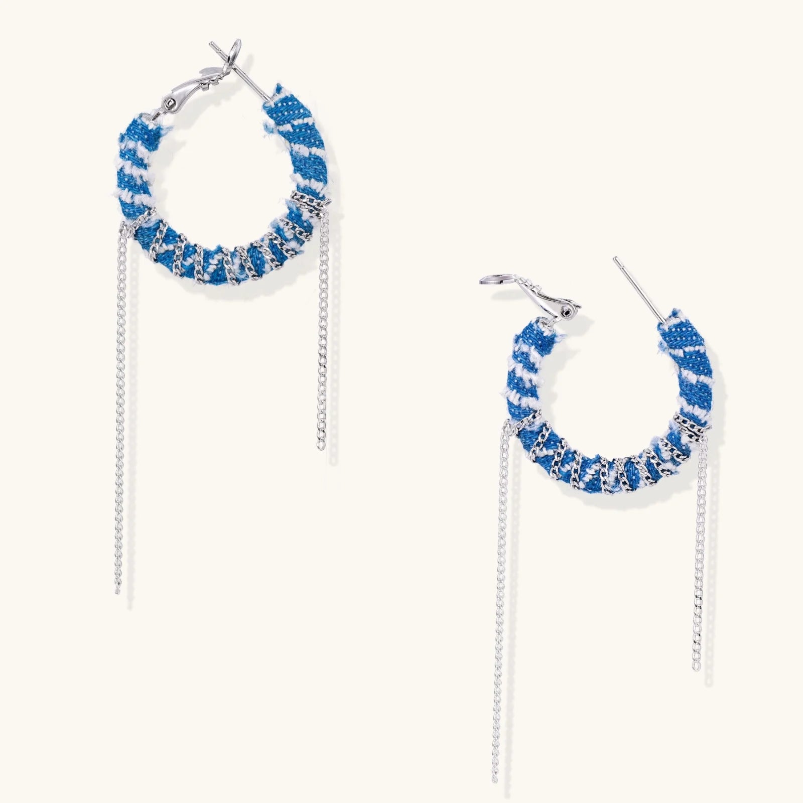 Medium hoop earrings wrapped in blue striped denim fabric with dangling silver chains on white background.
