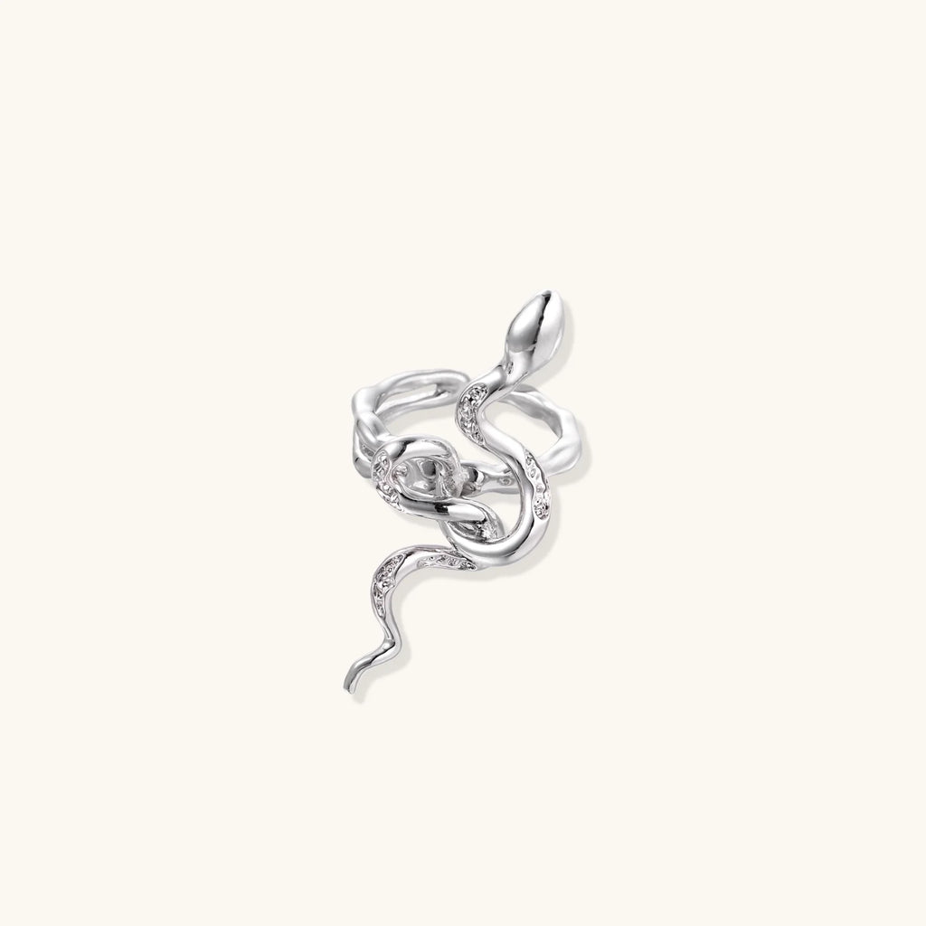 Sculptural white gold-plated snake ring with crystal accents coiling around finger in bold open design