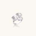 Silver-toned orchid ring with textured petals, pearl center accents, and sparkling zirconia stones on white background.