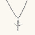 Silver-tone necklace with dimensional orb pendant, cross crown detail, and zirconia stones on twisted rope chain