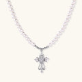 White pearl beaded necklace with ornate crystal-embellished cross pendant on white background, white gold plated finish