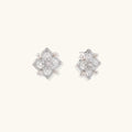 Ornate sterling silver stud earrings with mandala-inspired filigree pattern and four freshwater pearls on beige background
