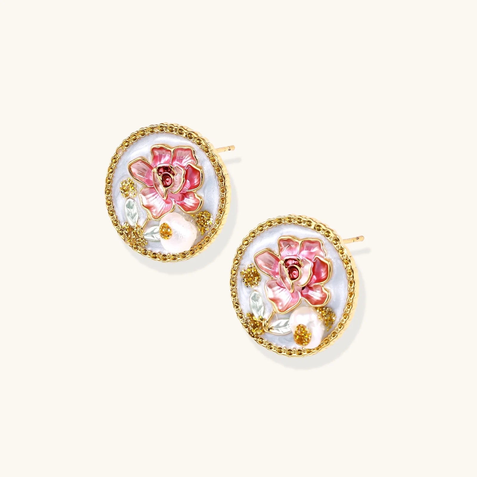 Gold-rimmed circular stud earrings with hand-painted pink peony enamel and pearl accents on white background