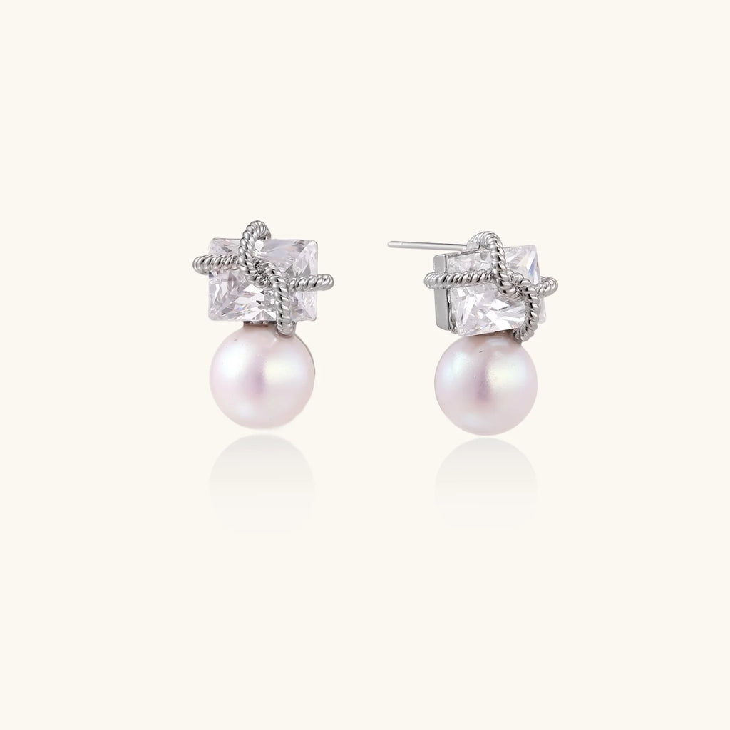 White gold stud earrings with square crystal stones in twisted frames and pink freshwater pearl drops below