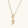 Sculptural gold snake pendant on delicate chain with toggle clasp, featuring smooth curves and polished 14K gold plated finish