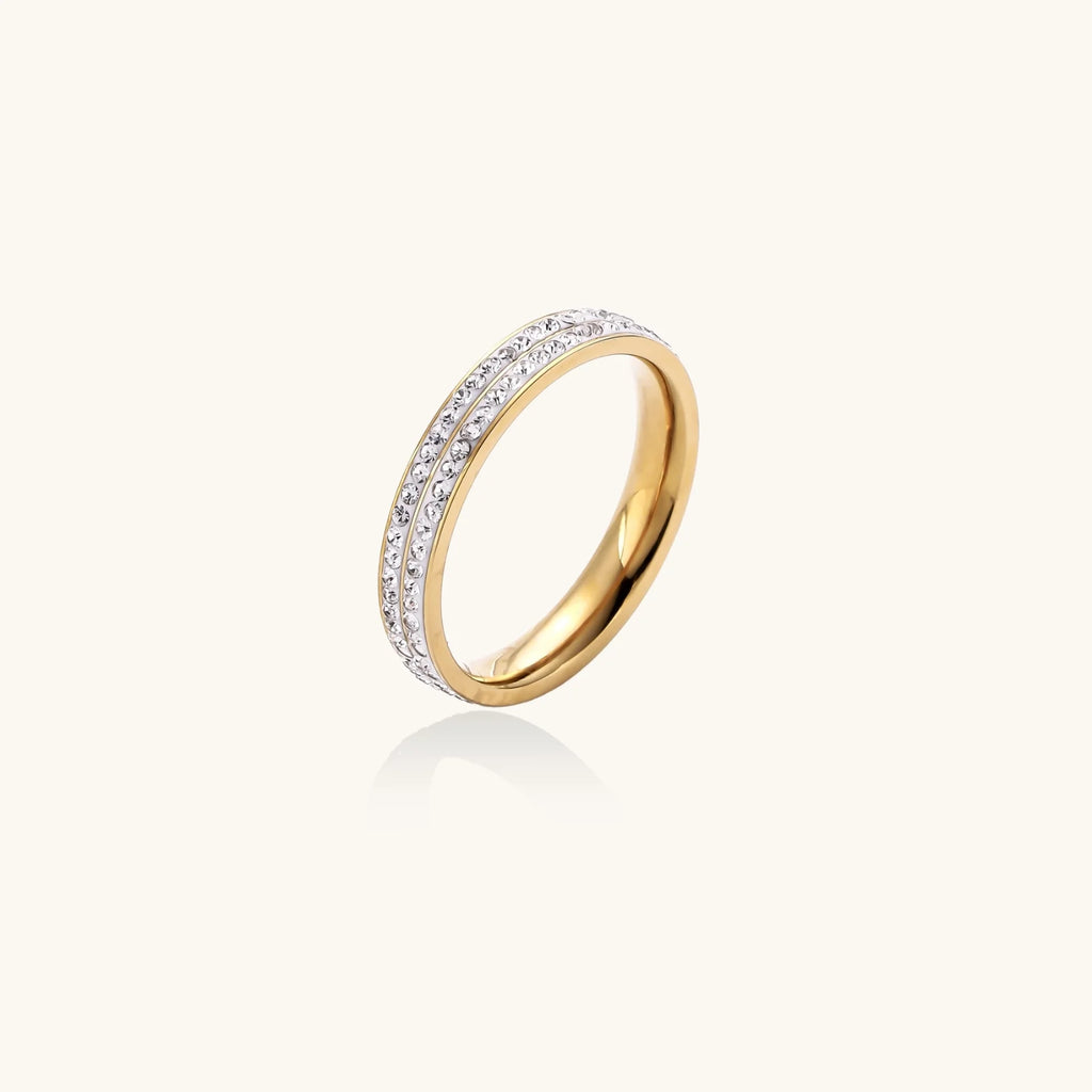 Gold-plated ring with two rows of clear rhinestones on white background