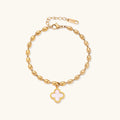18K gold-plated oval bead chain bracelet with quatrefoil clover charm featuring mother of pearl inlay on cream background