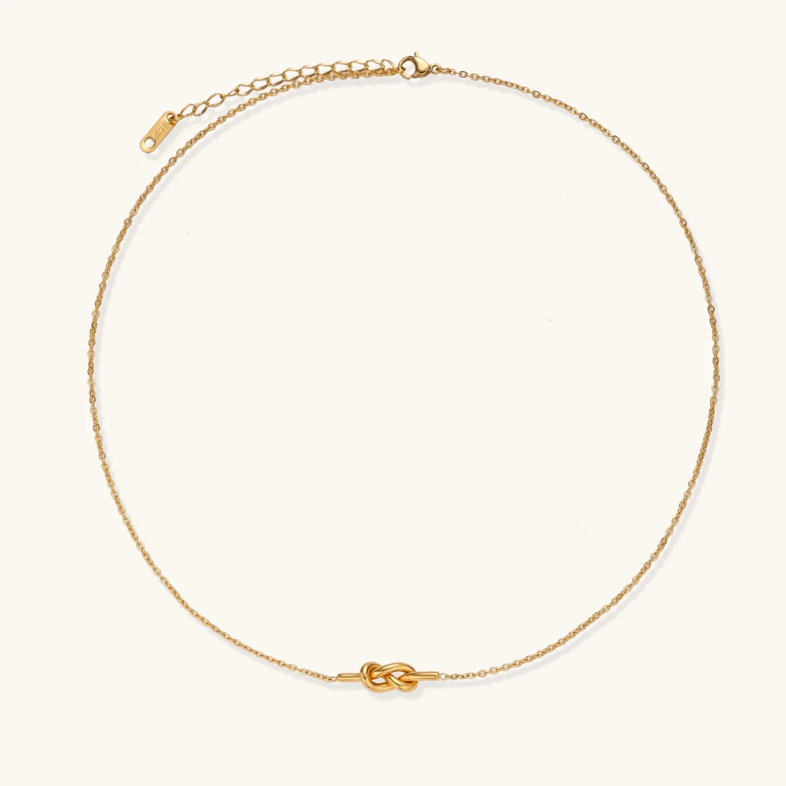 Dainty 18K gold plated necklace with infinity knot pendant on delicate chain against white background